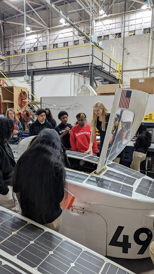 Students visiting a solar racing facility